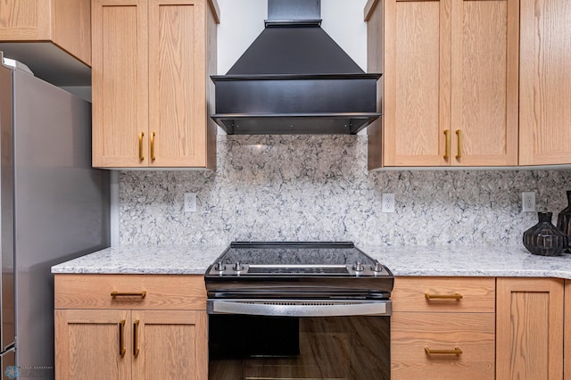 kitchen featuring custom range hood, backsplash, appliances with stainless steel finishes, and light stone counters