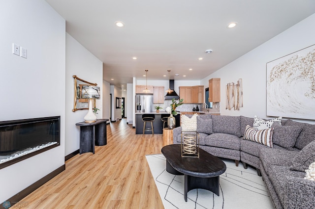 living room with light wood-type flooring and sink