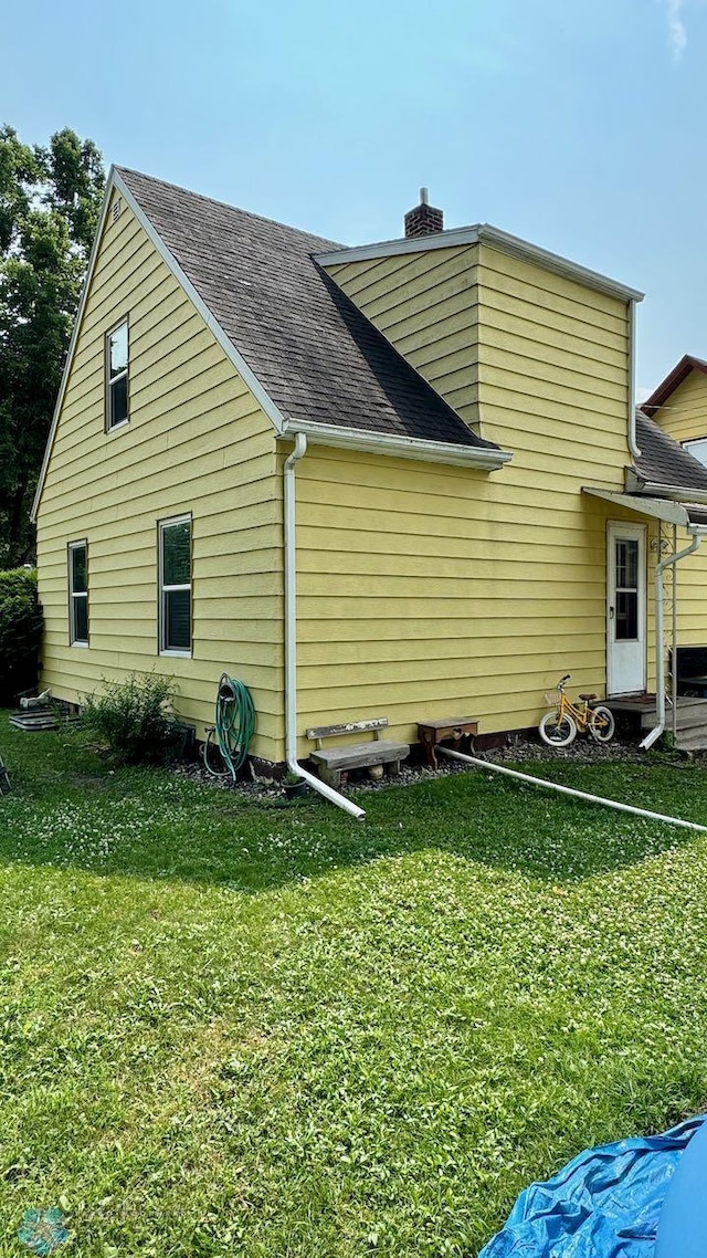 view of property exterior featuring a lawn