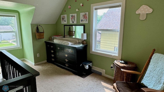 bedroom featuring carpet flooring, a crib, and vaulted ceiling