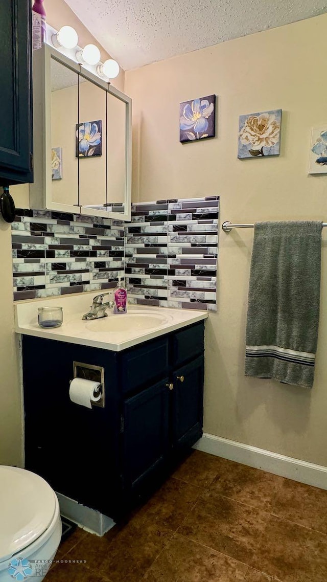 bathroom featuring tile patterned flooring, a textured ceiling, backsplash, toilet, and vanity