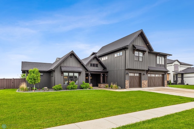 view of front of home with a garage and a front lawn