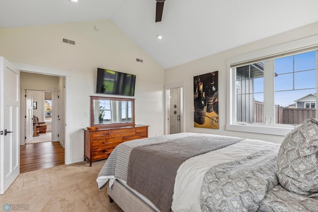 carpeted bedroom featuring high vaulted ceiling and ceiling fan