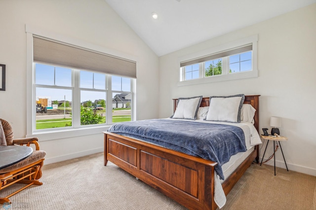 carpeted bedroom featuring multiple windows and vaulted ceiling