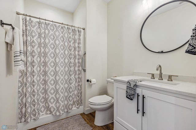 bathroom featuring vanity, toilet, and hardwood / wood-style floors