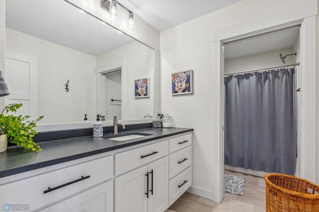 bathroom with tile patterned flooring and vanity