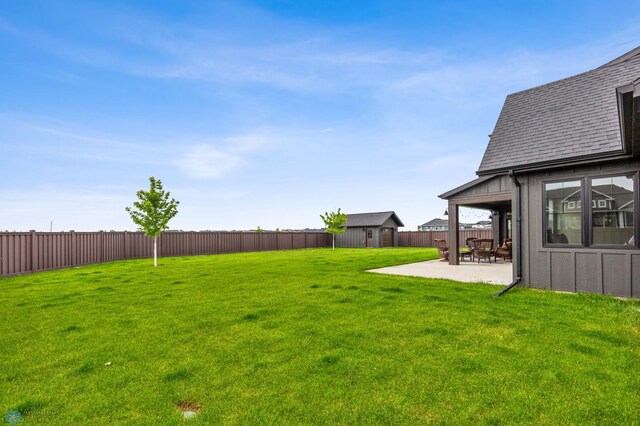 view of yard with an outdoor structure and a patio area