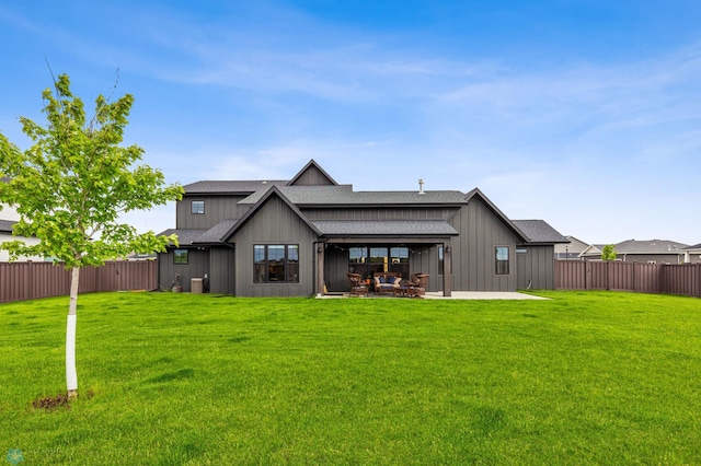 rear view of house featuring a yard and a patio area