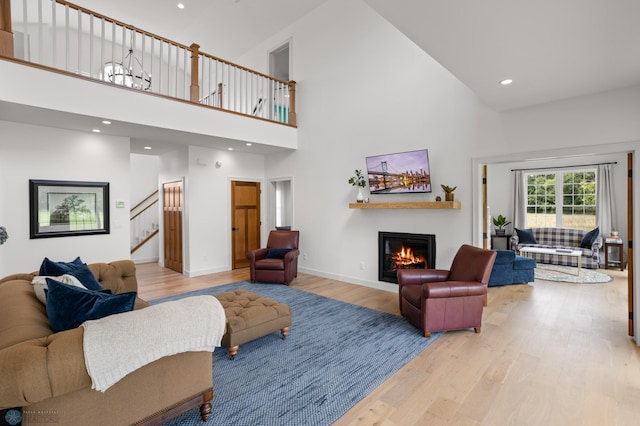 living room featuring high vaulted ceiling and hardwood / wood-style floors