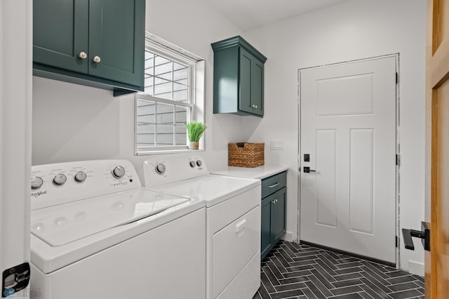 washroom with cabinets and washing machine and dryer