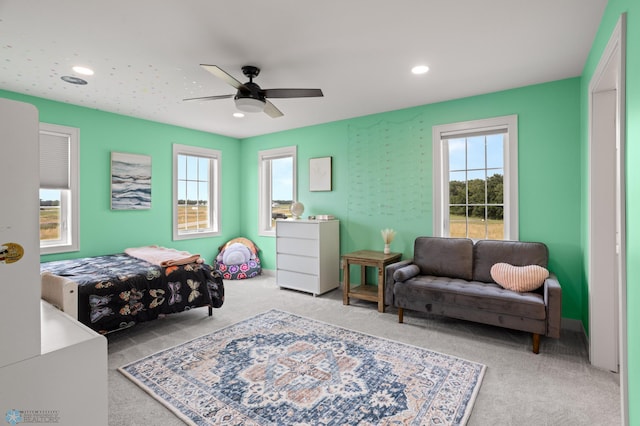 bedroom featuring light carpet and ceiling fan