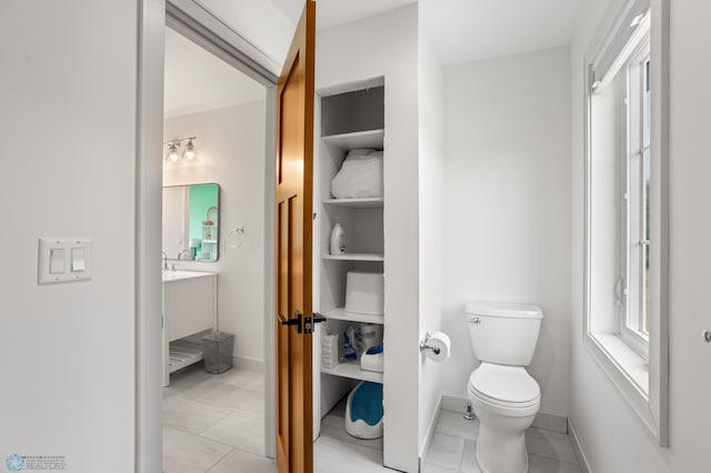 bathroom with vanity, tile patterned flooring, and toilet