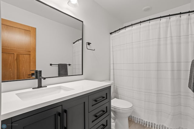 bathroom featuring tile patterned floors, vanity, and toilet