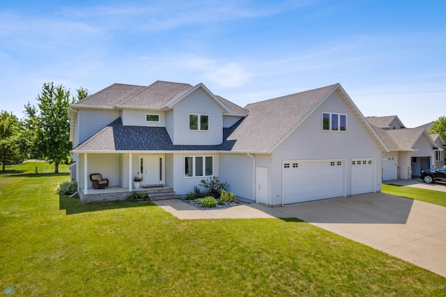 view of property with a garage and a front lawn