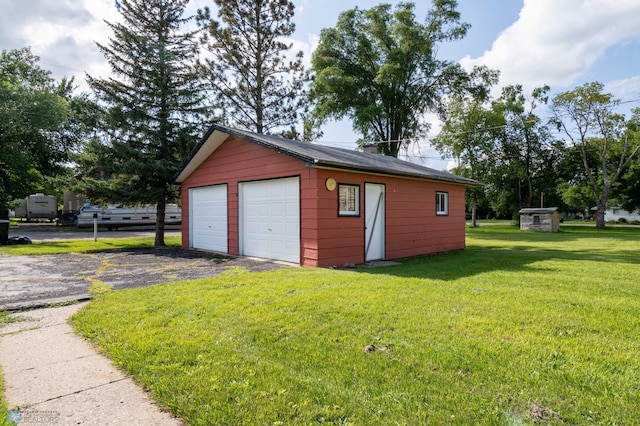 garage featuring a lawn