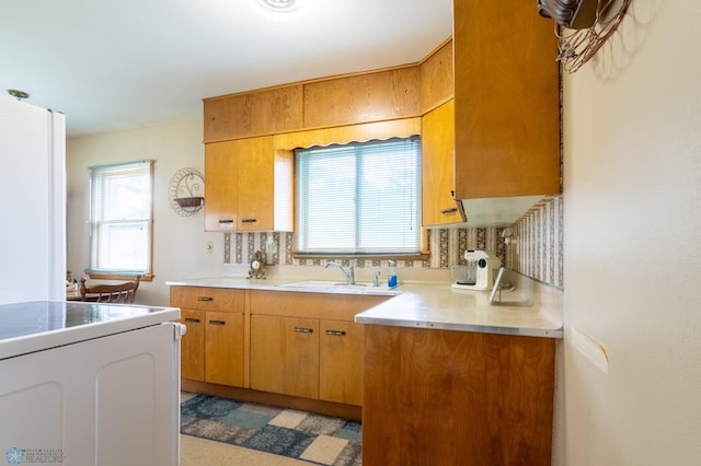 kitchen with white electric range oven and sink