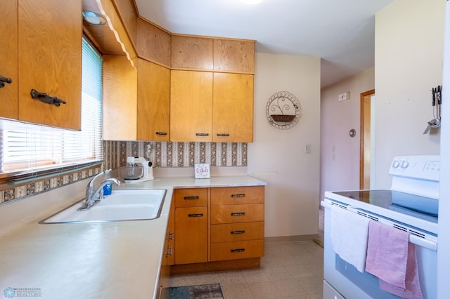 kitchen featuring sink, light tile patterned flooring, and electric stove