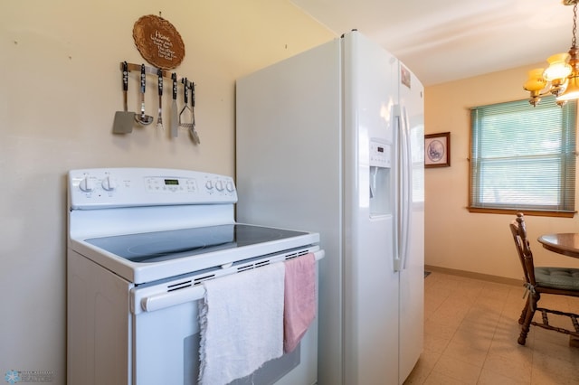 kitchen featuring light tile patterned flooring, a notable chandelier, hanging light fixtures, and white appliances