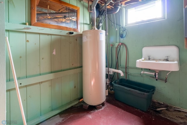 utility room featuring water heater