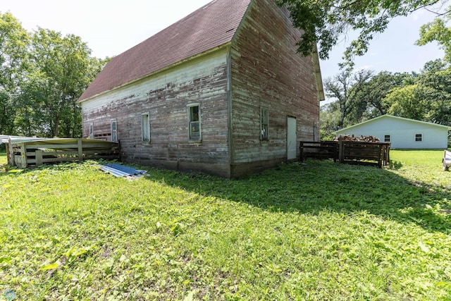 view of property exterior with a yard