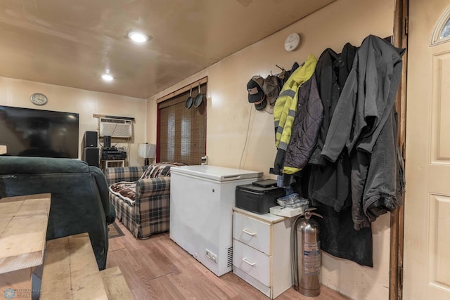 interior space with an AC wall unit and light wood-type flooring