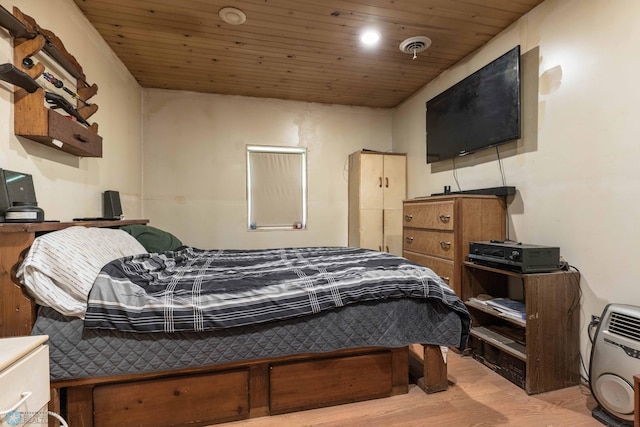 bedroom with light hardwood / wood-style floors and wooden ceiling