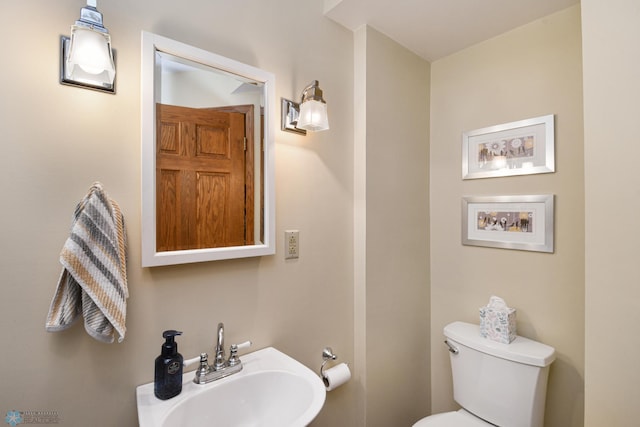 bathroom featuring toilet and sink