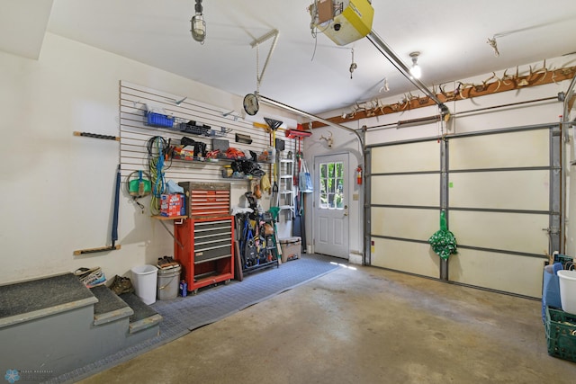 garage with a garage door opener and a workshop area