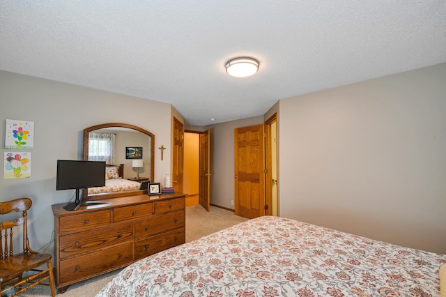 carpeted bedroom featuring a textured ceiling