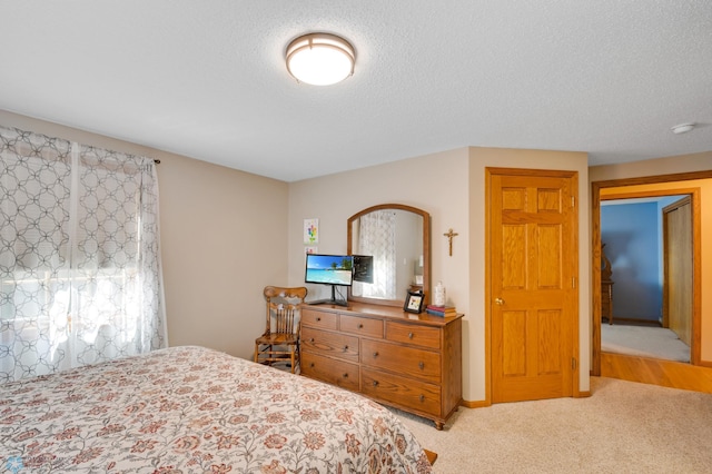 carpeted bedroom featuring a textured ceiling