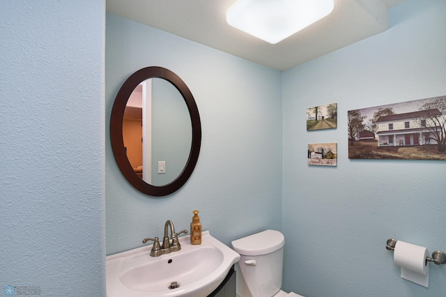 bathroom featuring toilet and sink