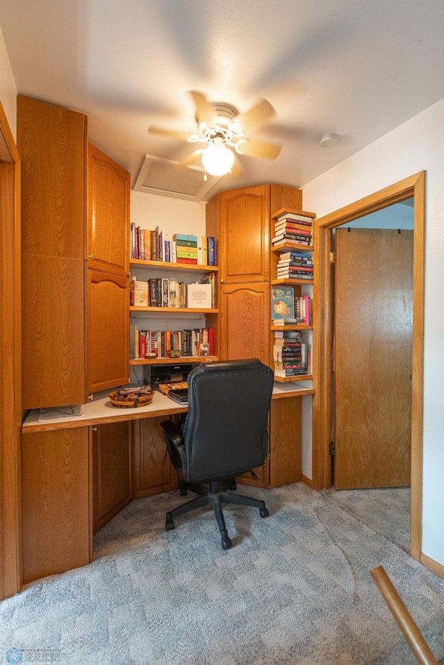 carpeted office space featuring ceiling fan