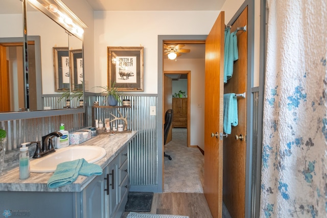 bathroom with hardwood / wood-style flooring, vanity, and ceiling fan