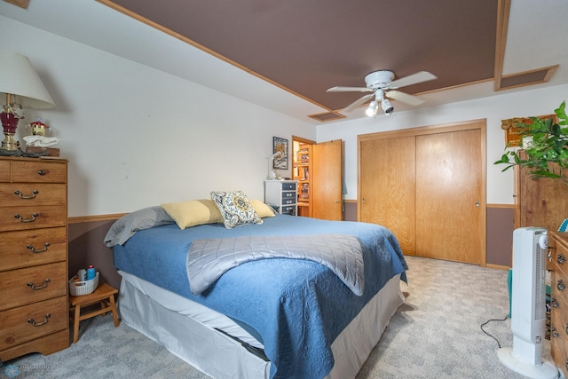 carpeted bedroom featuring a closet and ceiling fan