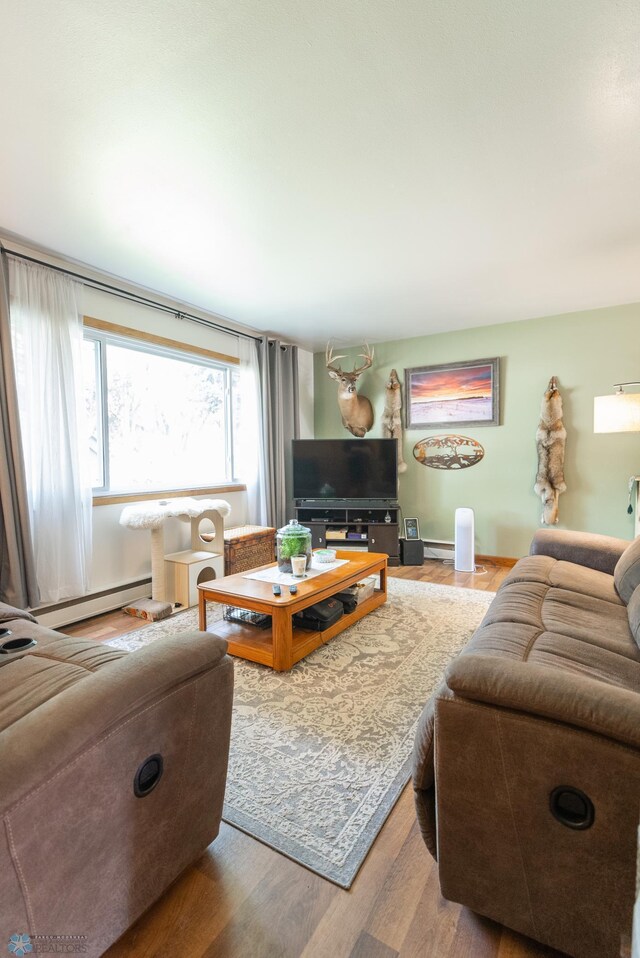 living room with a baseboard radiator and hardwood / wood-style floors