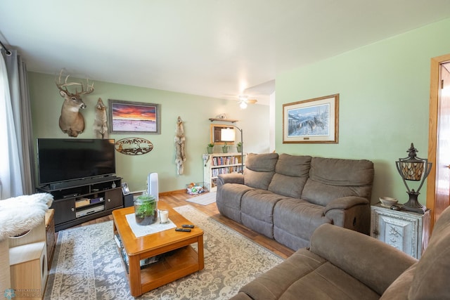 living room featuring light hardwood / wood-style floors and ceiling fan