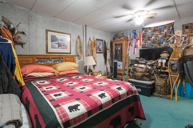 bedroom featuring ceiling fan and a paneled ceiling