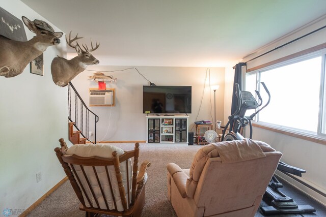 carpeted living room featuring a wall mounted AC and a wealth of natural light