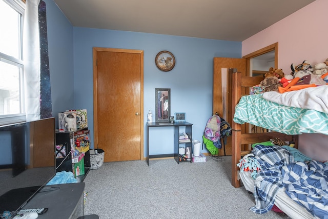 carpeted bedroom featuring multiple windows