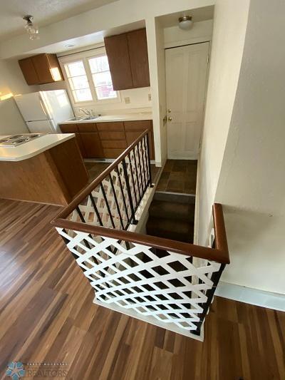 staircase with wood-type flooring