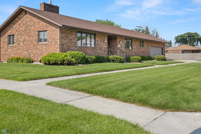 view of front facade featuring a garage and a front lawn