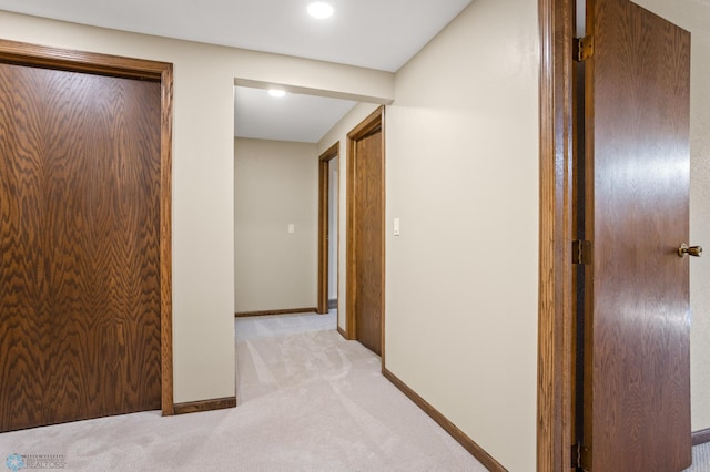 hall featuring light colored carpet