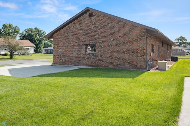 view of side of home with a lawn