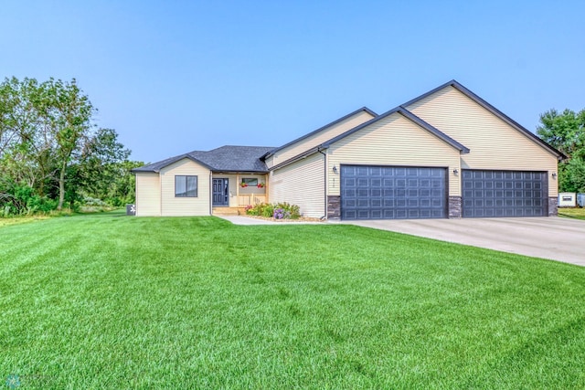 ranch-style house featuring a garage and a front yard