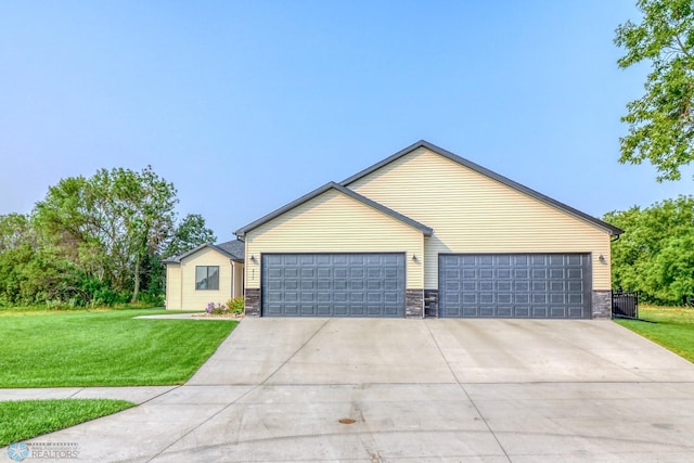 single story home with a garage and a front lawn