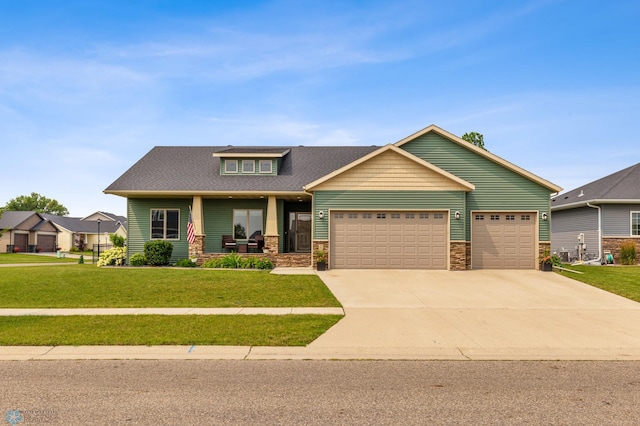 craftsman-style house featuring a garage, a porch, and a front yard