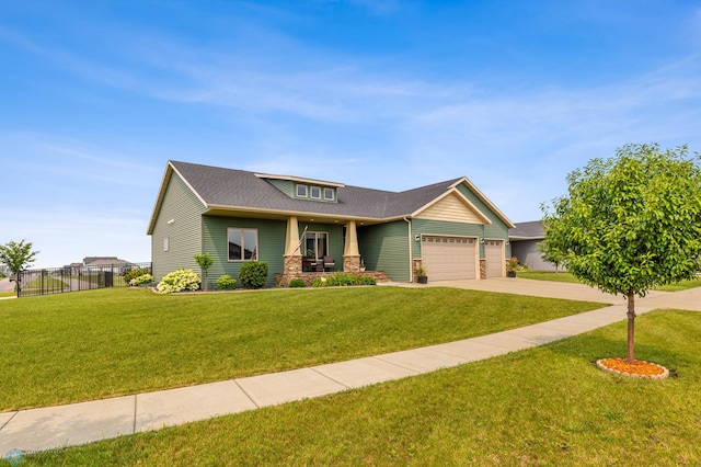 craftsman-style house with a garage and a front lawn