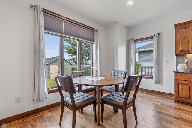 dining space with light hardwood / wood-style flooring