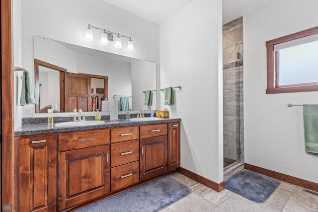 bathroom with vanity, tile patterned floors, and tiled shower