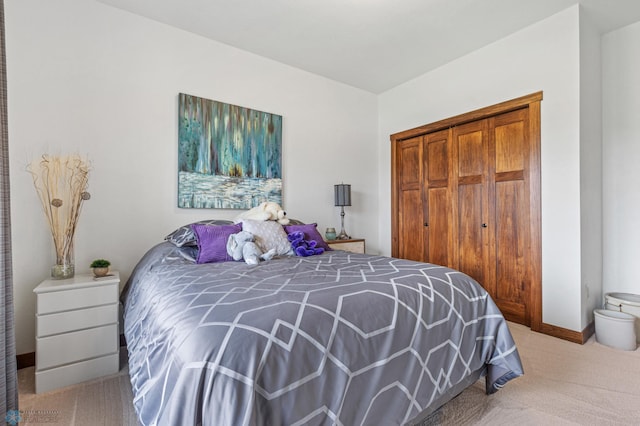 bedroom featuring a closet and light colored carpet